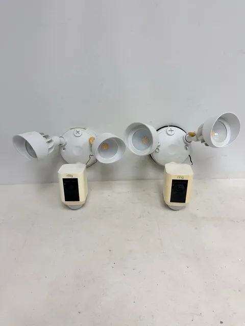 Lot of 2 - Ring Wired Outdoor Floodlight Cameras in White. FOR PARTS, DON’T WORK