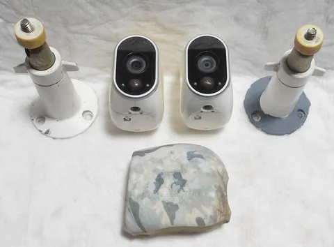 ARLO NETGEAR VMC3030 SECURITY CAMERAS WITH MOUNTS - LOT OF TWO (2)