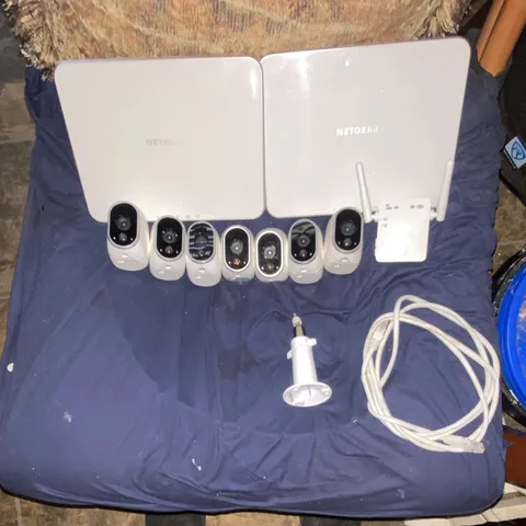 Arlo security cameras W/ 2 base stations and Wi-Fi extender. 5 magnet wall mount