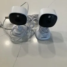 two white AOQEE C1 2K Indoor/Outdoor Security Cameras