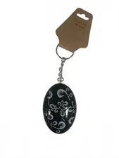 Chic Black Oval Keychain with Elegant White Floral Swirls – Carry Style Wherever